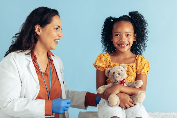 Pediatric with girl patient on blue background