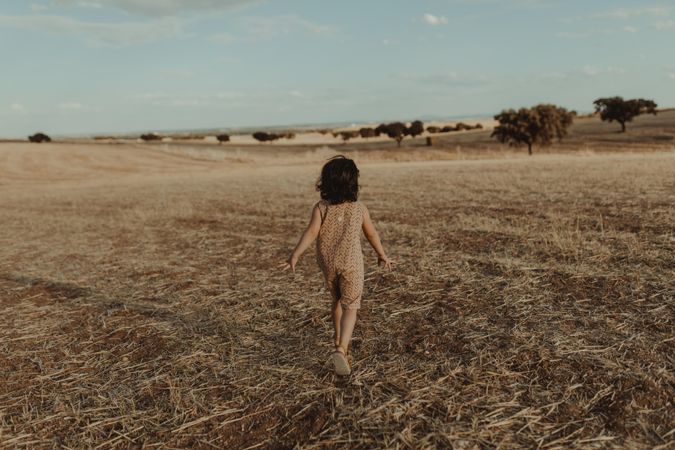 Child walking in a open field