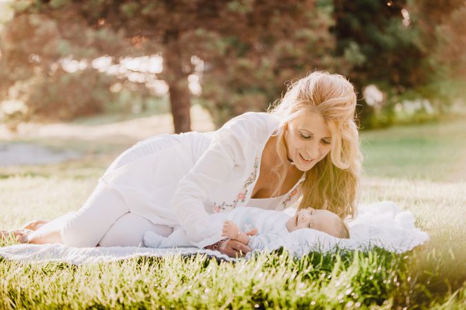 baby with down syndrome lying on a blanket with her grandmother
