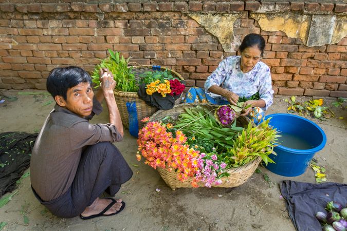 Bagan, Myanmar - June, 25 2012: people selling flowers on street