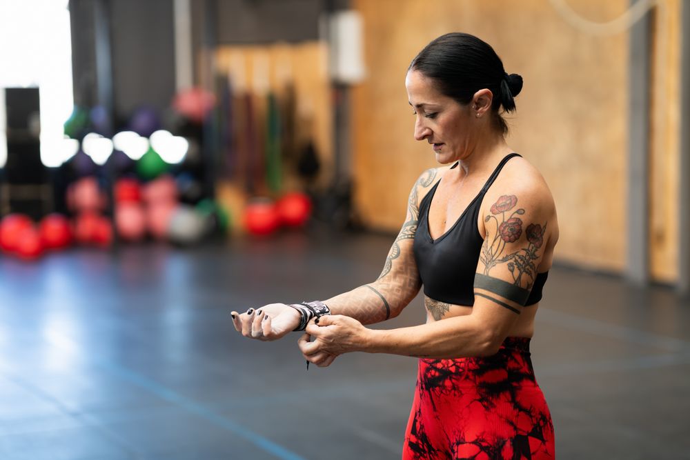 Fit woman adjusting band on arm