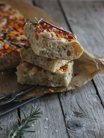Pieces of fresh focaccia on wooden table