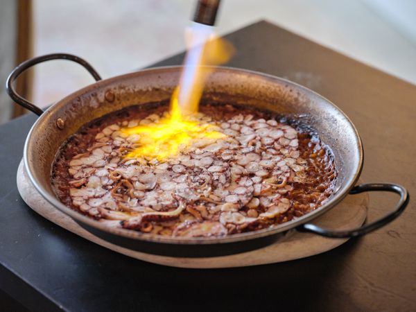 Pan with restaurant paella and burner