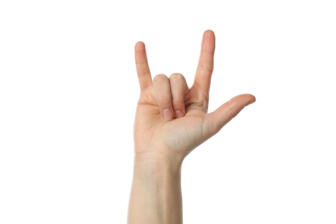 Woman hand giving the horns gesture, isolated on bright background