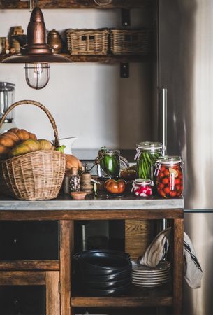Rustic kitchen with pickled vegetables on counter, vertical composition