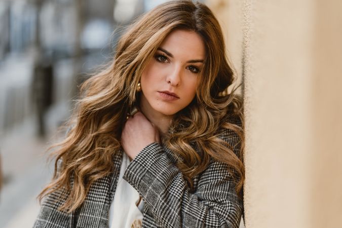 Woman leaning on wall on street