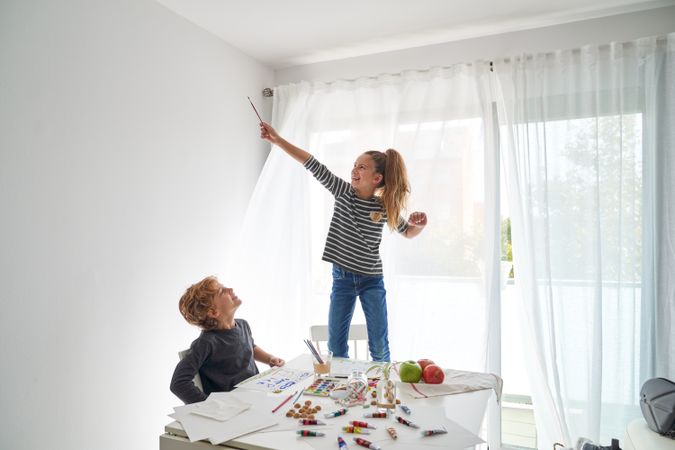 Brother and sister having fun while drawing