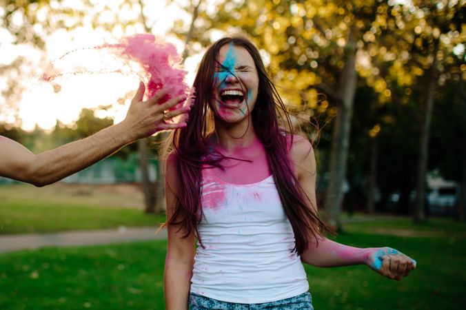 Friends playing with holi festival at the park