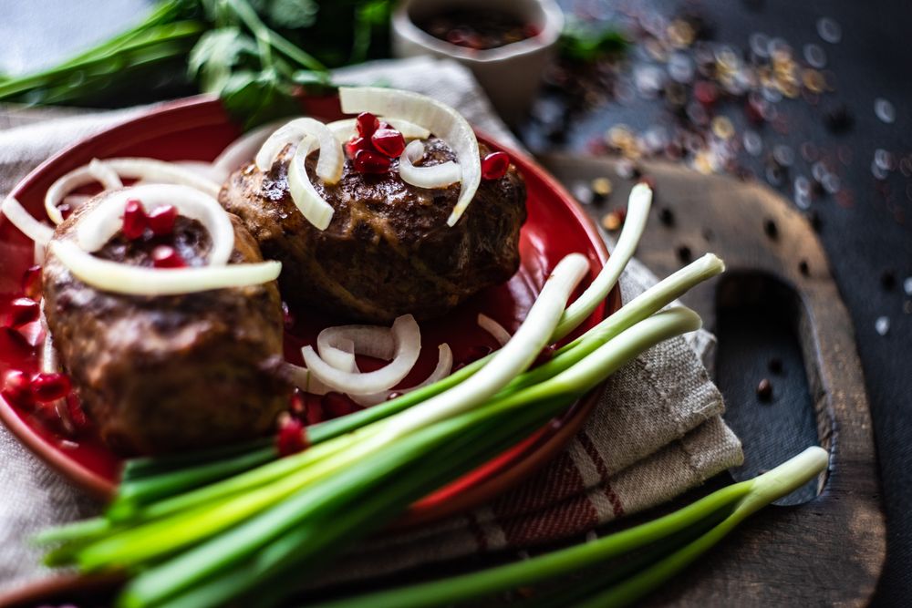 Plate of Georgian abkhazura cutlets on plate with spring onions
