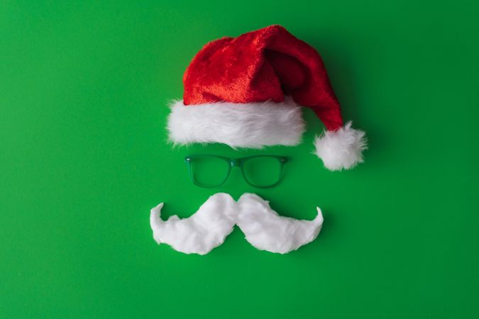 Santa hat with green background with glasses and mustache
