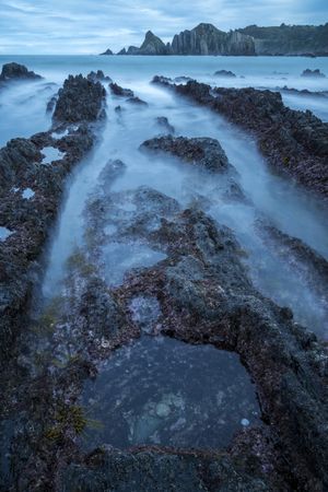 Foggy landscape of Playa de Gueirua rock seashore