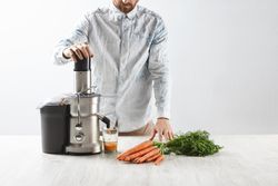 Man juicing carrots
