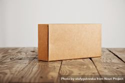 Rectangular cardboard box on wooden table bDYMr0