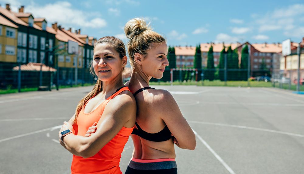 Sportswomen posing with crossed arms