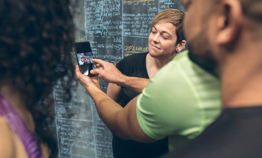 Athletes looking at the mobile of a gym mate