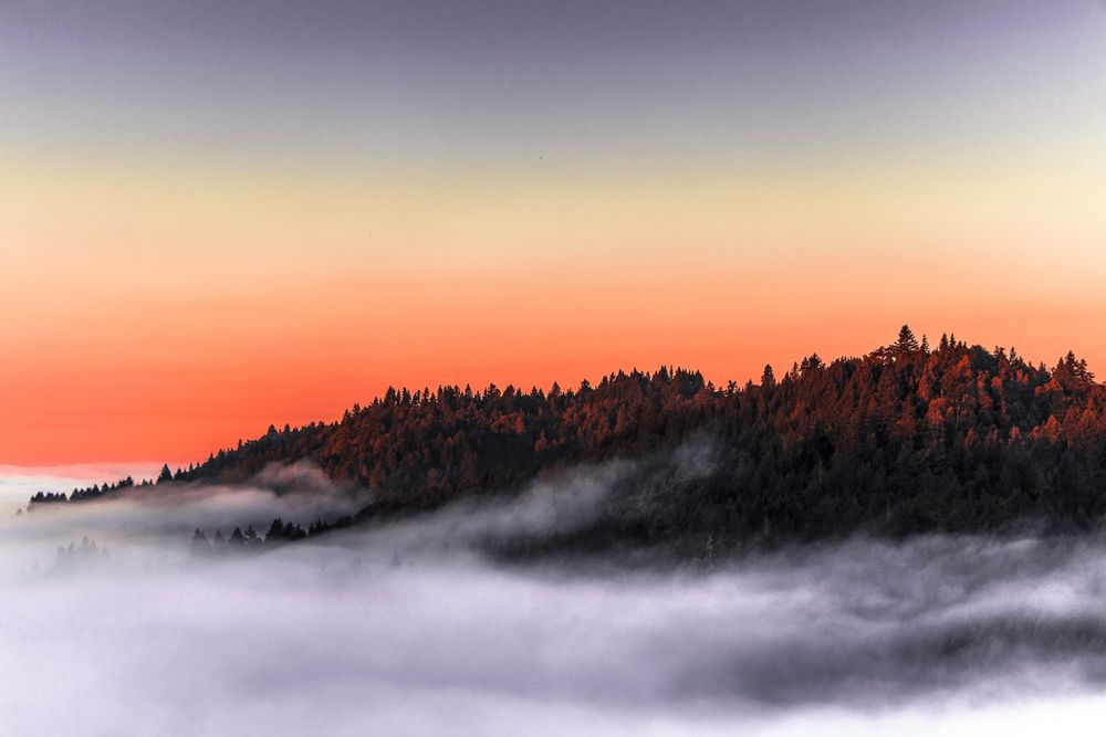 Clouds in the mountain at orange sunset or sunrise