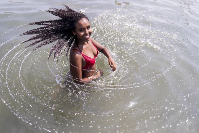 Black woman spinning in a pool of water