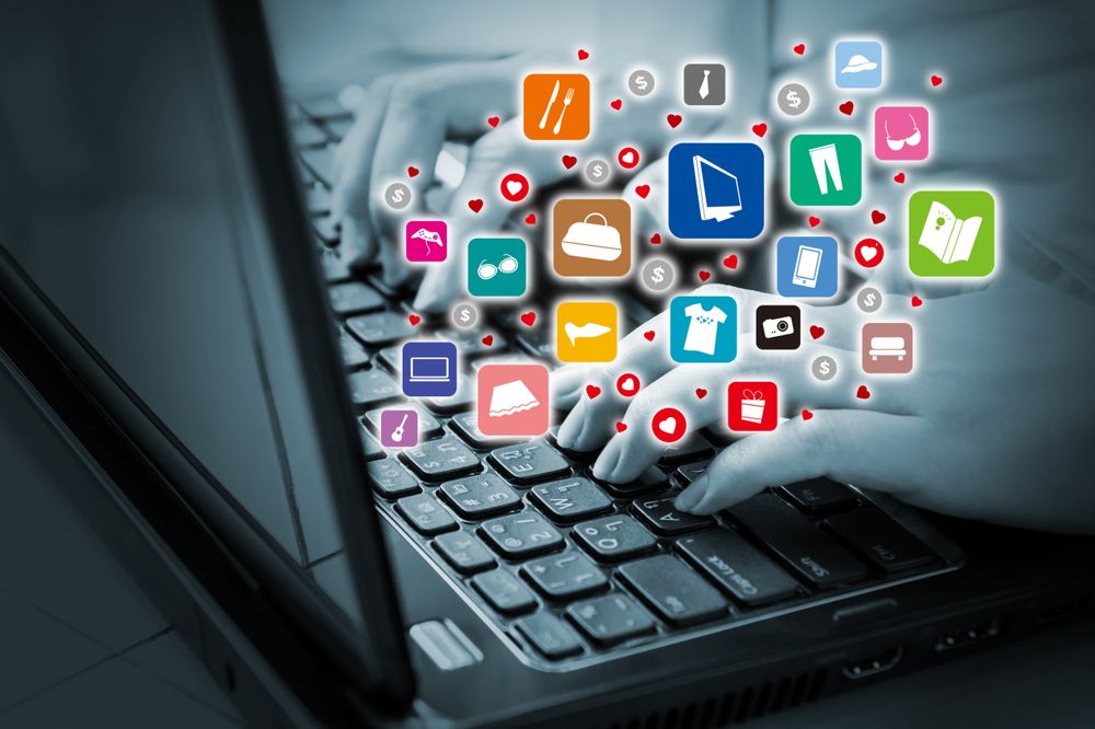 Hands Typing on a Keyboard with Shopping Icons Around