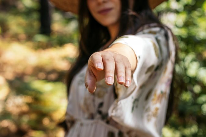 Hand of a woman reaching towards the camera