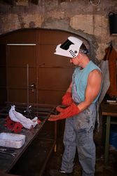 Professional worker wearing gloves in welding workshop