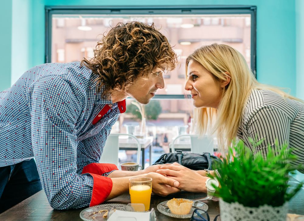 Couple looking eyes and holding hands