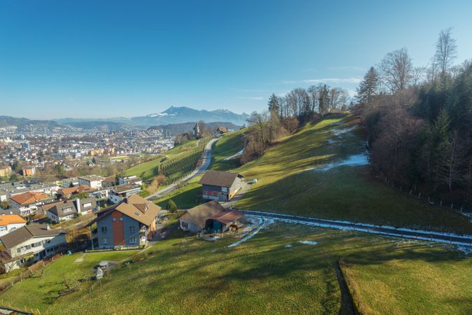Town on green slope of mountains
