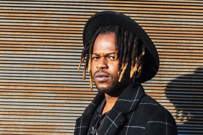 Stylish Black man with dreadlocks on street