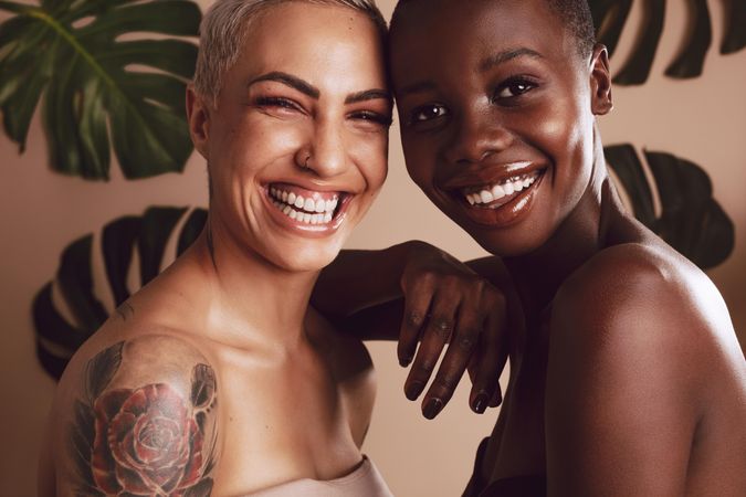 Two multi-ethnic women standing together and smiling