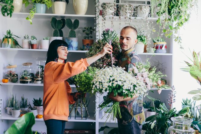 Man and woman making bouquets in the flower shop.