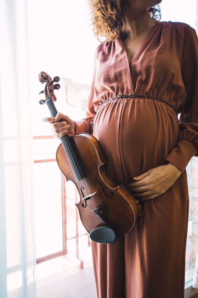 Young smiling woman with violin