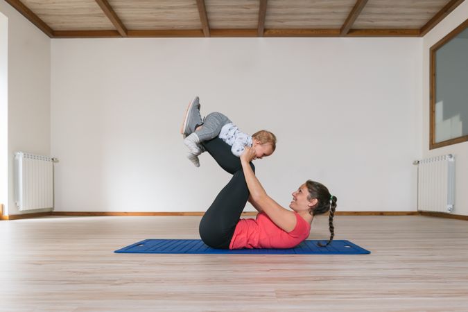 Mother exercising with baby in gym