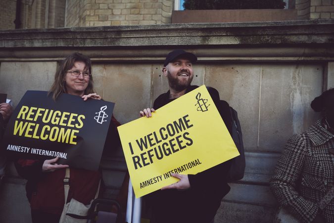 London, England, United Kingdom - March 19 2022: Man and woman with Amnesty International sighs