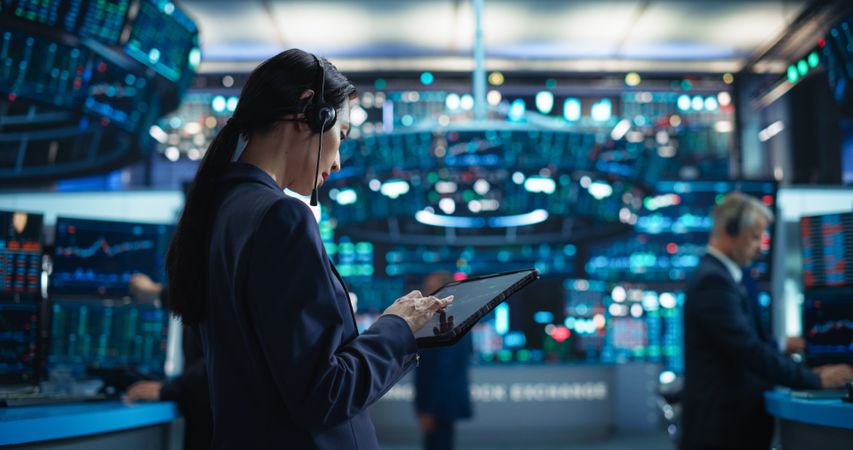 Successful Stock Exchange Manager Wearing Headphones, Working in Modern Office.