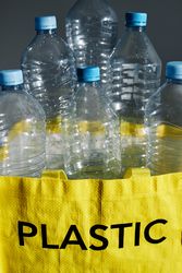 Plastic bottles in bag prepared for recycling