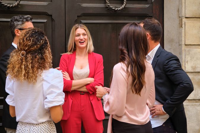 Group of colleagues gathering near wooden door