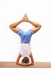 Advanced yoga inversion: Salamba Sirsasana with leg variation on eco-friendly mat