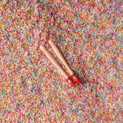 Doll legs buried in colorful sprinkles