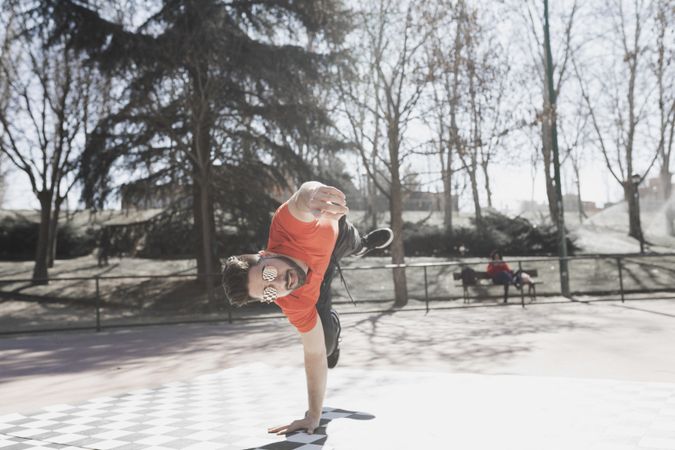 Man dancing break dance in park