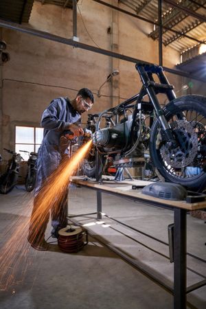 Adult male mechanic working in professional workshop
