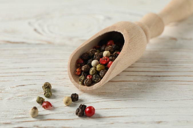 Close up of of wooden scoop full of spice with copy space