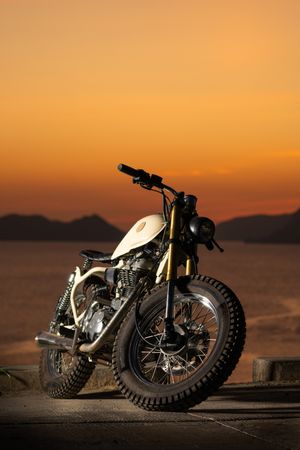 Motorbike near sea during sunset