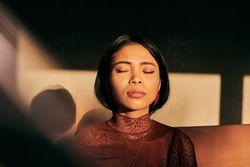 Woman sitting with eyes closed
