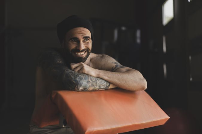 Smiling shirtless guy in gym