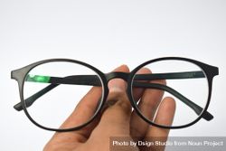 Spectacles being held by hand 5wXgNv