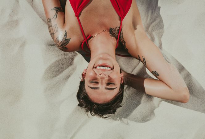 Close up of woman upside down with closed eyes relaxing on beach