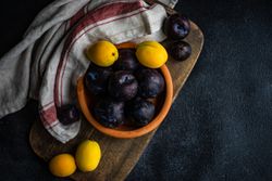Ripe pitted fruits on cutting board