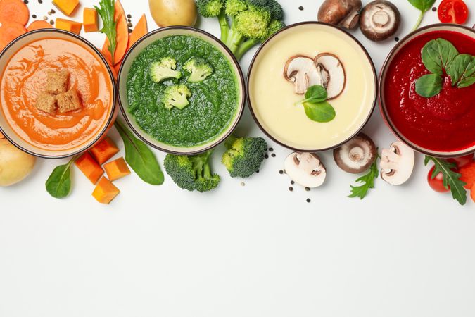 Colorful autumn soups arranged on top of picture with copy space