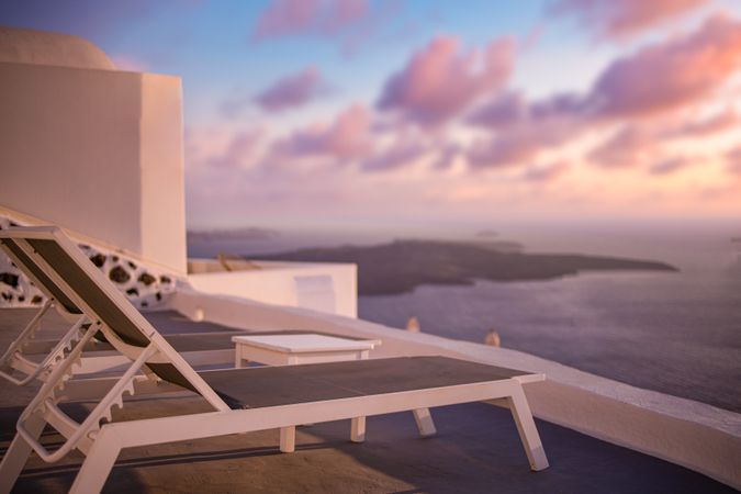 Reclining chairs at sunset by the sea