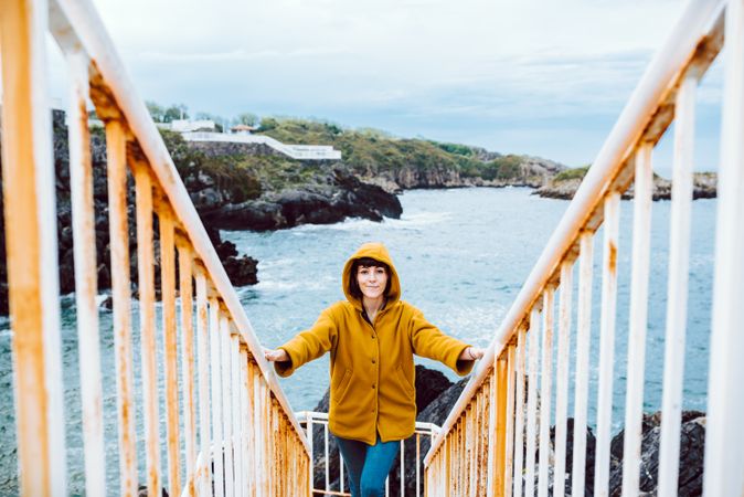 Woman standing on steps near sea