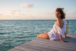 Young woman on pier near sea